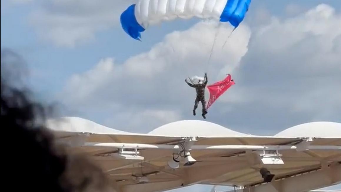 storyful 322222 parachutist left dangling from stadium roof as pregame stunt goes awry.00 01 08 28.still002