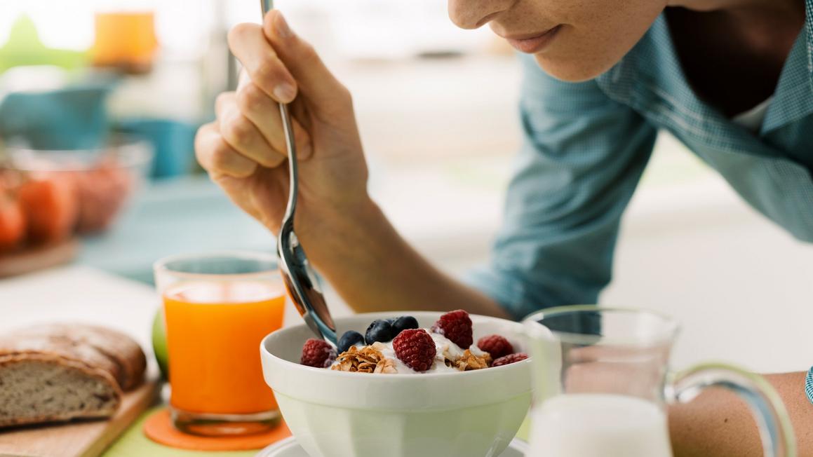 woman eating yogurt fruit